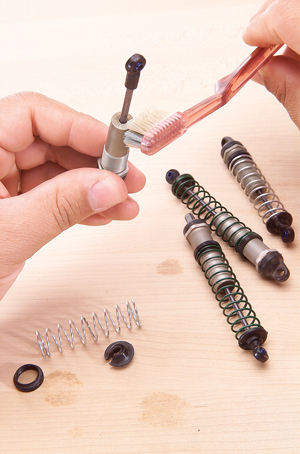 A toothbrush is the perfect tool for cleaning shocks.